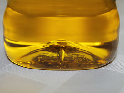 brown liquid filled glass container on white surface thumbnail