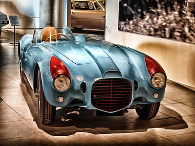 blue coupe on white tiles thumbnail