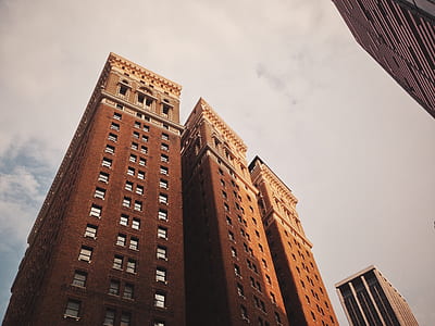 low angle photography of brown concrete building thumbnail
