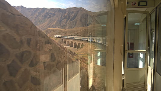 window view of white train over bridge thumbnail