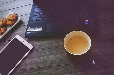 laptop computer and mug on table thumbnail