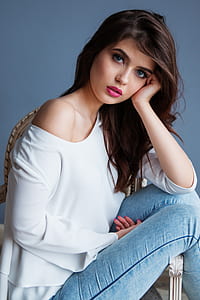 woman in white long-sleeved top and blue jeans thumbnail