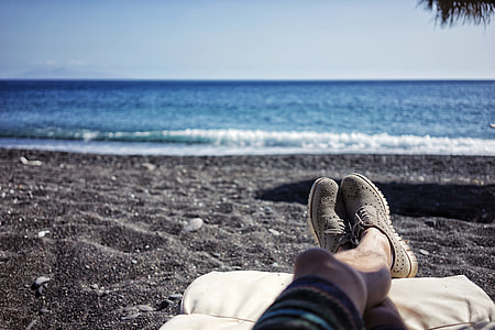 person lying at the beach during day thumbnail