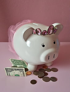 white ceramic piggy bank near coins and banknote thumbnail