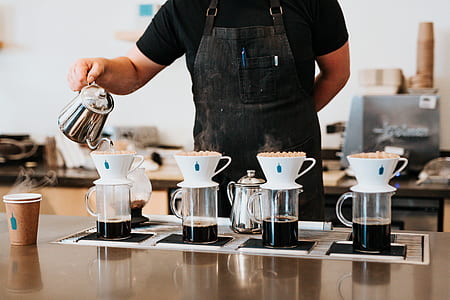 person pouring coffees on mugs thumbnail