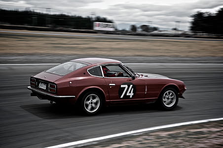 red sports car driving on race track thumbnail