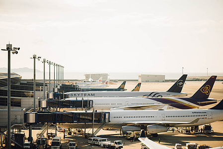 five airplane park on airport under cloudy skies thumbnail