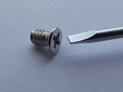 bolt and screwdriver on white surface thumbnail
