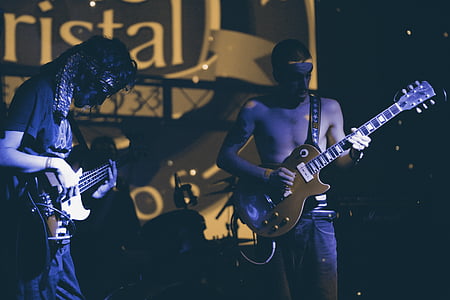 two men playing electric guitars thumbnail