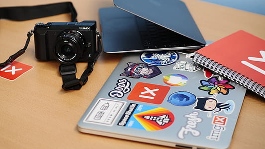 black DSLR camera near MacBook and books thumbnail