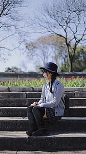 woman sitting sideways on bricked stairs thumbnail