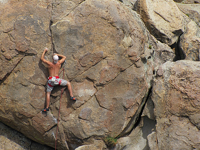 topless man rock climbing during daytime thumbnail
