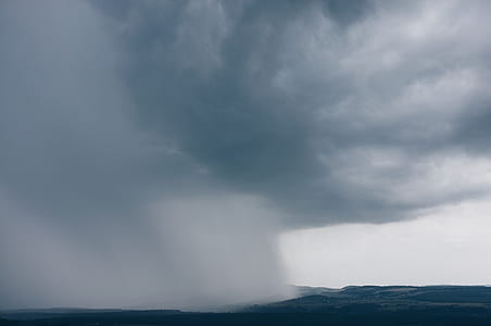 white cloudy sky pouring rain at daytime thumbnail