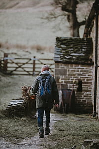 person walking on road during daytime thumbnail