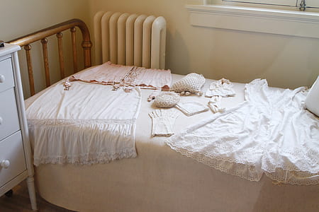 white radiator heater beside a bed thumbnail