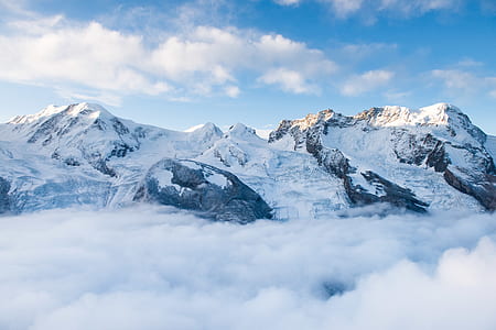 mountain covered by snow under blue sky during daytime thumbnail