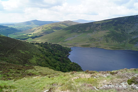 body of water surrounded with mountains thumbnail