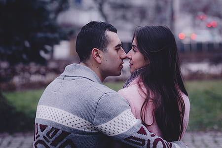 selective focus photography of man and woman touching nose thumbnail