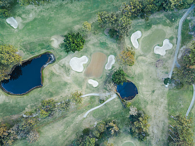 aerial view of grass field with ponds thumbnail
