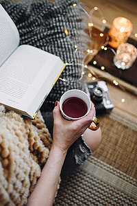 Woman drinking tea and reading book thumbnail