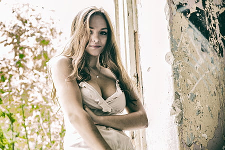 woman standing near gray concrete wall thumbnail