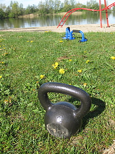 black kettle bell on grass field thumbnail