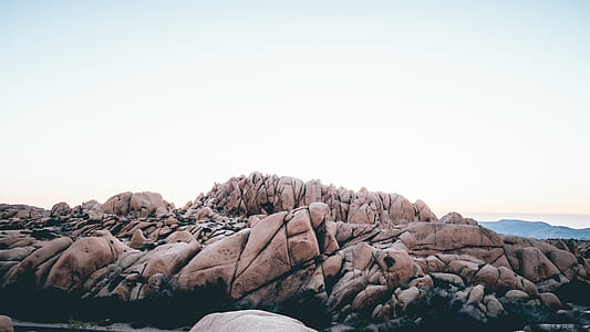 brown rock formation under white sky during daytime thumbnail