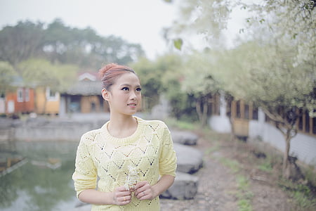 selective focus photo of woman wearing yellow top thumbnail