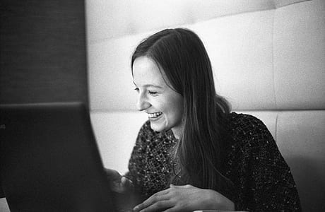 woman smiling towars laptop thumbnail