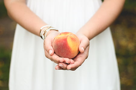 red apple in person's palms thumbnail