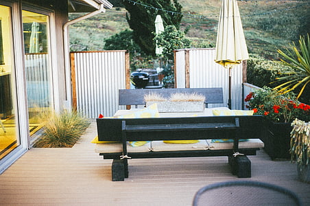 two black padded benches beside concrete house thumbnail