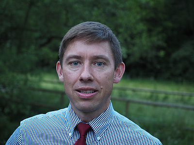 man in white and black pinstripe button-down top thumbnail