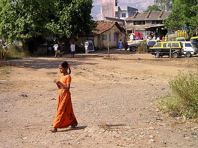 girl walking near trees at daytime thumbnail