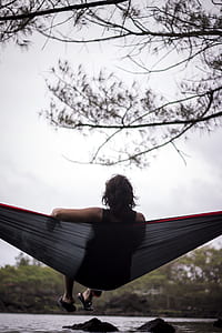 person in black tank top sitting on hammoch thumbnail