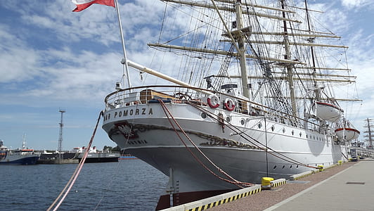 docked white sailing ship on body of water thumbnail