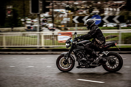 man driving motorcycle near park at daytime thumbnail