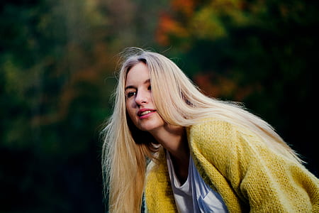 woman in yellow sweater in bokeh photograph thumbnail