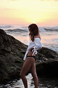 woman wearing white long-sleeved top and black panty thumbnail