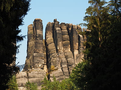 gray and white rock formations under blue skies during day thumbnail