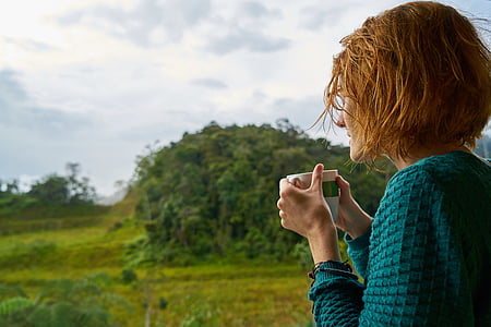woman holding white ceramic mug thumbnail