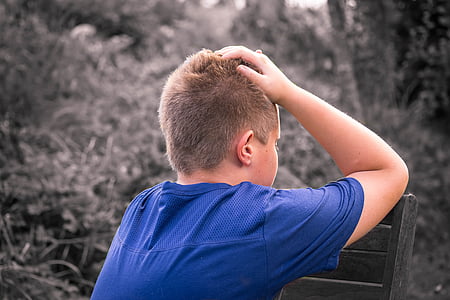 photography of boy wearing blue crew-neck t-shirt thumbnail