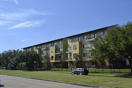 gray SUV near beige apartment building thumbnail