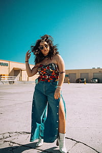 woman wearing orange and gray strapless shirt and blue denim bottoms thumbnail