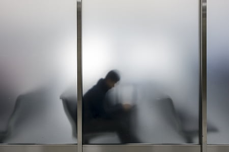 silhouette of man behind frosted glass window thumbnail