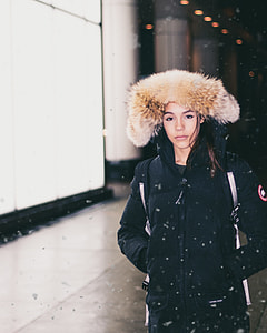 woman in black and brown parka coat during winter thumbnail