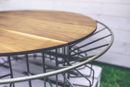 round brown wooden board on gray metal stand thumbnail