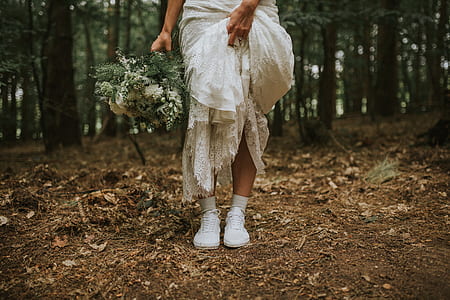 woman standing white holding white flowers in forest thumbnail