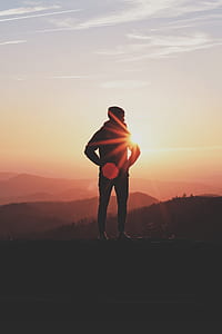 men's standing on mountain under sunset thumbnail