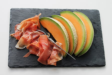 slice of bacon and fruits on rectangular black chopping board thumbnail