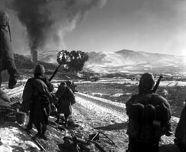 Marines watching explosions to flush out enemies, Korean War thumbnail